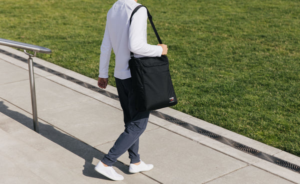 Person carrying the Cambiata over their shoulder with the shoulder strap.